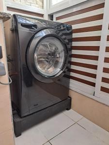 a washing machine is sitting in a room at appartement bien situé a SALAM in Agadir