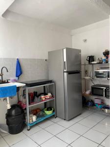 a kitchen with a stainless steel refrigerator in it at Casa-Patio Bugambilias in Temixco +33 photos