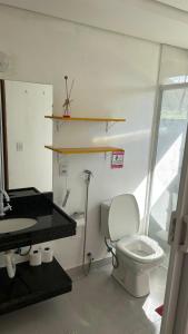 a bathroom with a white toilet and a sink at Pousada Cantinho da Mata in Paraty +47 photos