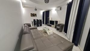 a living room with a couch and a television at Ramela in Dakar