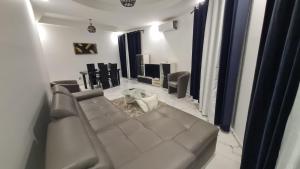 a living room with a couch and some chairs at Ramela in Dakar