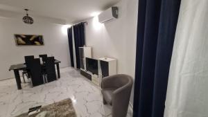 a living room with a chair and a television and a desk at Ramela in Dakar