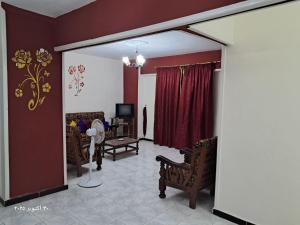 a living room with chairs and a couch and a television at شقة بحر إسكندرية Bianchi Breeze in Alexandria +10 photos