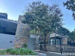 a brick house with a tree in front of it at Katlego in Bloemfontein