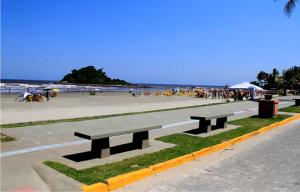 イタニャエンにあるPousada Espaço Vista Marのビーチの近くのビーチにベンチがいくつかある