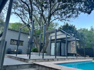 a house with a pool in front of it at Katlego in Bloemfontein