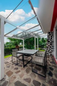 a patio with a table and two chairs at Casa Maravilha II in Caniço