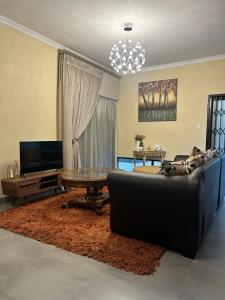 a living room with a couch and a table at Katlego in Bloemfontein
