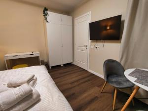 a bedroom with a bed and a chair and a table at Piata Romana Suites & apartments - Pumo Properties in Bucharest