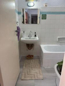 a bathroom with a sink and a bath tub at Traditional Villa Stella in Archangelos