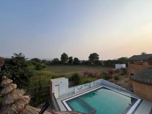 a swimming pool on the side of a house at IRWINA-In rhythm with nature in Pushkar