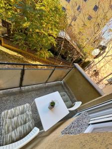 a table and two chairs and a white table and a table and chairs at Meet Prishtina Apartments in Pristina +2 photos