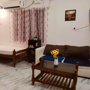 a living room with a couch and a table at Ebenezer Stay in Trivandrum