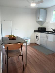 a table with a bowl of fruit on it in a kitchen at Maresia's House in Madalena do Mar