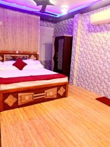 Ένα ή περισσότερα κρεβάτια σε δωμάτιο στο Shree Narayana Guest House