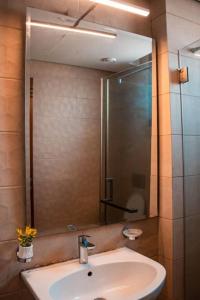 a bathroom with a sink and a mirror at 2 - 4 bedroom apartments in Eko Atlantic City in Lagos