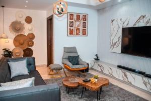 a living room with a couch and a tv at 2 - 4 bedroom apartments in Eko Atlantic City in Lagos