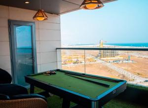 a pool table in a room with a view of the ocean at 2 - 4 bedroom apartments in Eko Atlantic City in Lagos