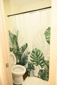 a bathroom with a toilet and green leaves at Mid-City Rustic Retreat in Baton Rouge +44 photos