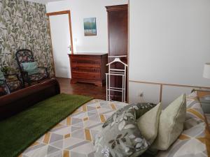 a bedroom with a bed and a dresser in it at Les 4 Portes in Le Mesnillard +3 photos