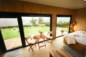 Un dormitorio con una cama y una mesa y sillas. en ermiglamping, en Jince