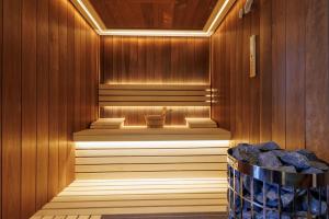 a sauna with a bench in a wooden wall at Hypnotic Thermal Villas with private SPA in Banya