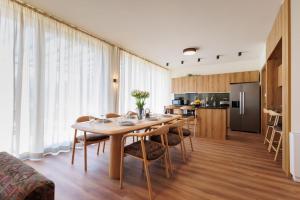 a dining room and kitchen with a table and chairs at Hypnotic Thermal Villas with private SPA in Banya