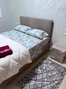 a bedroom with a bed and a nightstand next to it at appartement fes in Fès