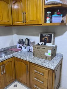 a kitchen with a pizza box sitting on a counter at appartement fes in Fès