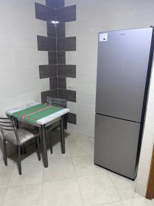 a kitchen with a table and a refrigerator at appartement fes in Fès