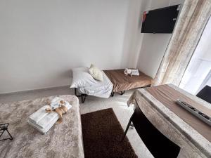 a small room with two beds and a table at Home Sorrento in Torre del Greco