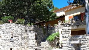 a stone wall next to a stone building at Om'Sleeping B&B in Laudun