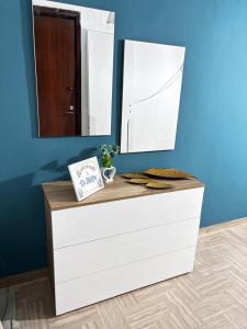 a mirror on top of a dresser in a room at Home Sorrento in Torre del Greco