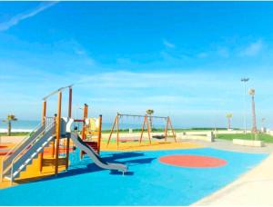an empty playground with a slide in a park at Nest Surf Housse Anza in Agadir