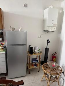 a kitchen with a white refrigerator and a table at Lucy Home in Forlì del Sannio +19 photos