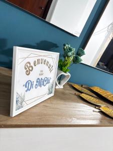 a sign on a table next to some scissors at Home Sorrento in Torre del Greco