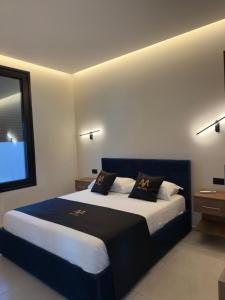 a bedroom with a large bed with two pillows on it at Mia Villa in Draç +21 photos