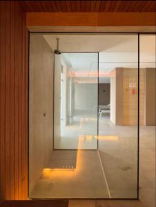 a glass door in a room with a hallway at SUÍTE EM COPACABANA - APART HOTEL 200m DA PRAIA, PISCINA, ACADEMIA in Rio de Janeiro
