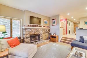 een woonkamer met een stenen open haard en een bank bij 2 Mi to Diamond Peak! Corner-Unit Condo with Hot Tub in Incline Village