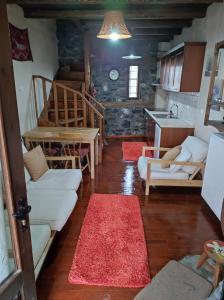 a living room with white couches and a table at Villa Aretousa in Palaios Agios Athanasios