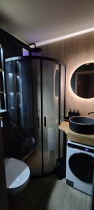 a bathroom with a shower and a toilet and a sink at JOJO Loft Comfort Dzelzavas & Cozy Stay & Breakfast Gift in Riga +38 photos