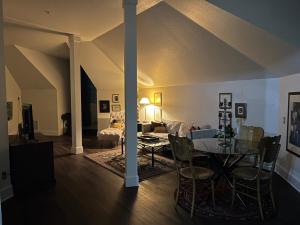 a living room with a table and a couch at Innkeeper Suite at The Currier Inn in Greeley