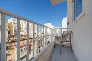 a bench sitting on the balcony of a building at Dar One - Self catering & self check in apartments by Tritoni Hotels in Il-Gżira