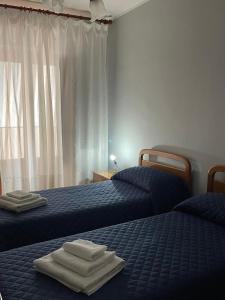 a bedroom with two beds with towels on them at Casa vacanze di Angelo in Isnello +9 photos
