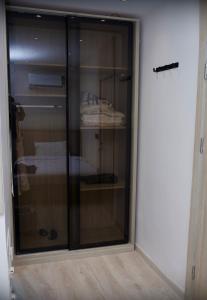 a glass cabinet in the corner of a room at Lumen Residence in Cairo