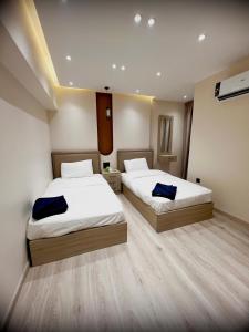 a bedroom with two beds at Lumen Residence in Cairo +13 photos