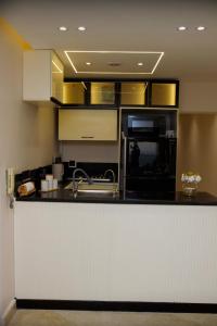 a kitchen with a sink and a counter top at Lumen Residence in Cairo