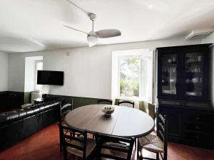 a living room with a table and a couch at Maison en pierre rénovée avec jardin et piscine privative chauffée in Hyères