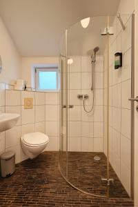 a bathroom with a shower and a toilet and a sink at Airport Messe Hotel in Düsseldorf +61 photos