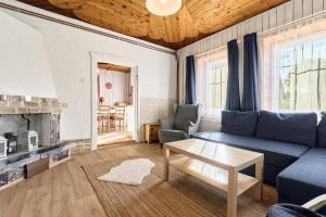 a living room with a blue couch and a table at Chalupa pod stromy in Kovářská +33 photos